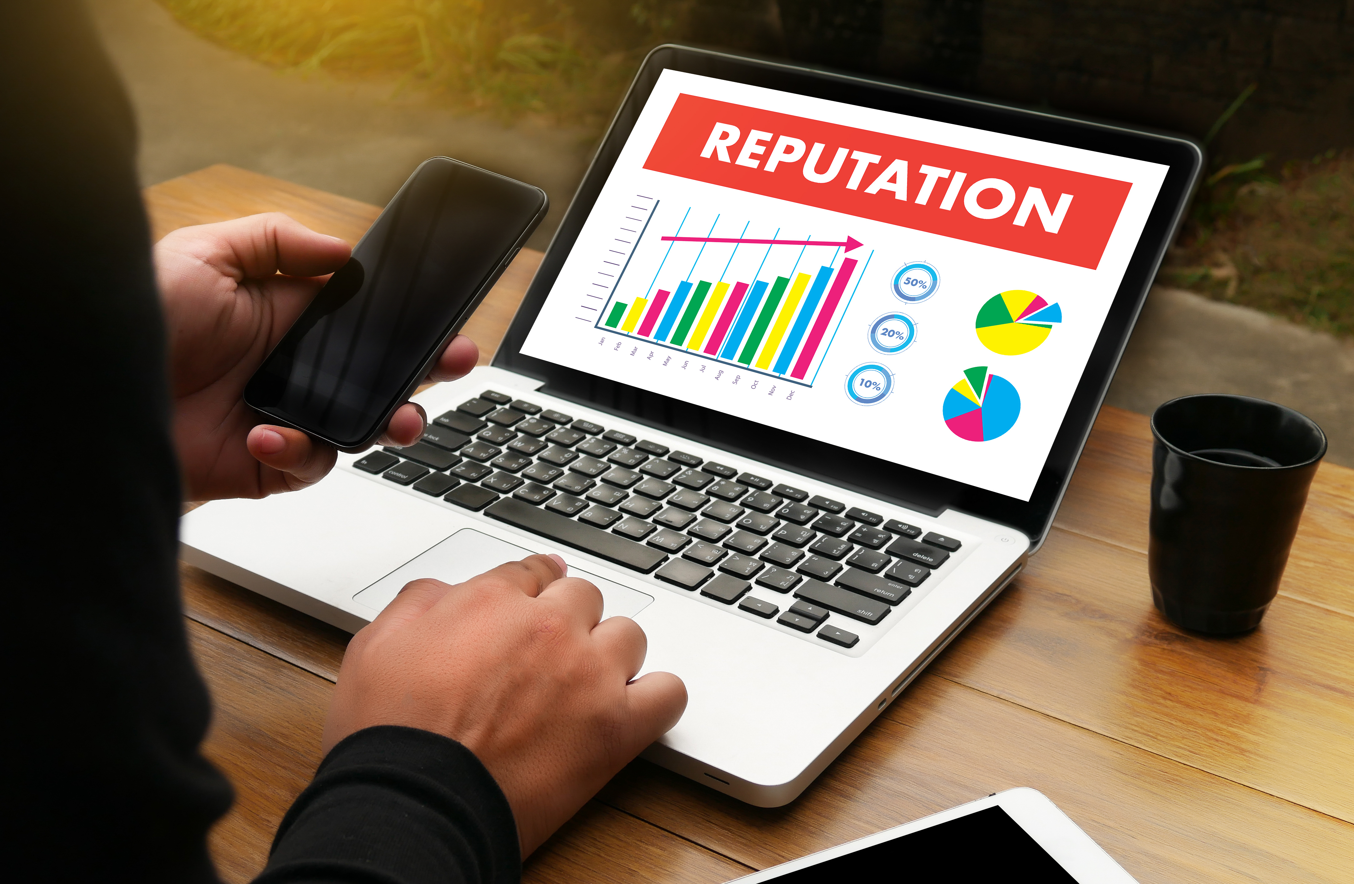 the word 'reputation' displayed on a laptop
